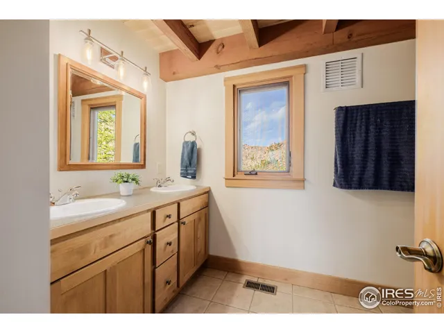 a bathroom with a sink a mirror and a window