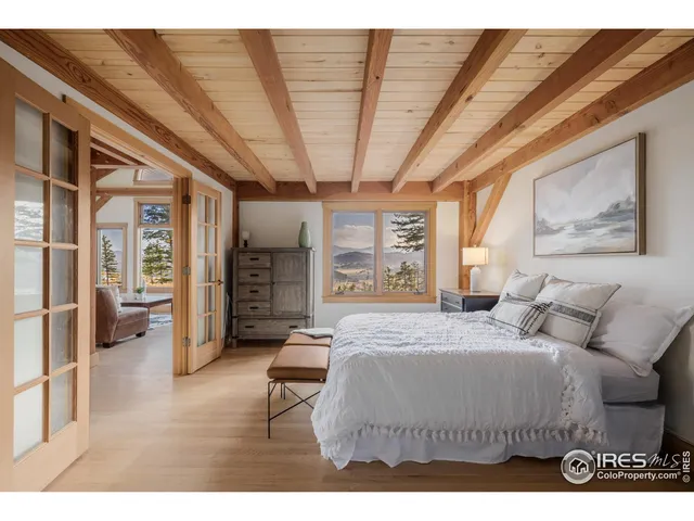 a bedroom with a large bed couch and a window