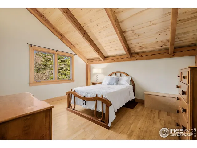 a bedroom with a bed next to a window