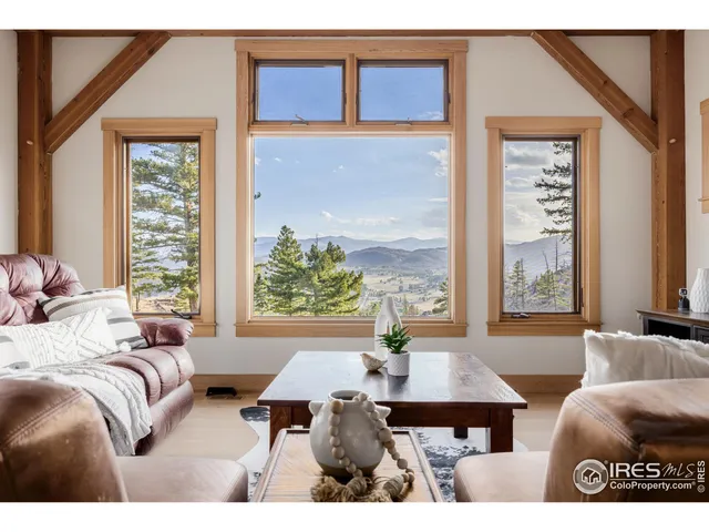 a living room with furniture a window and a table