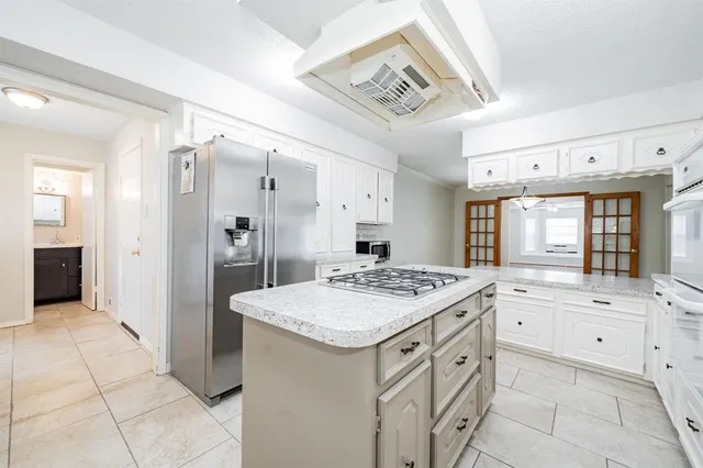 a kitchen with granite countertop white cabinets and sink