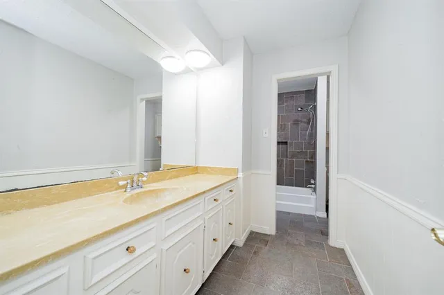 a white bath tub sitting next to a white toilet