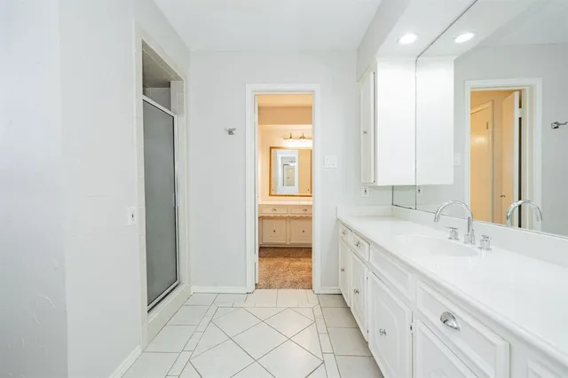 a bathroom with a double vanity sink and a mirror