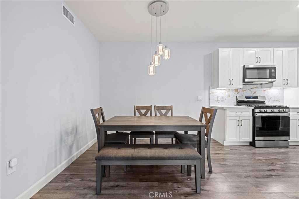 20000 Plum Canyon Road, Unit 1326 Saugus, CA 91350 - Photo 12 of 39 a view of a dining room with furniture and wooden floor