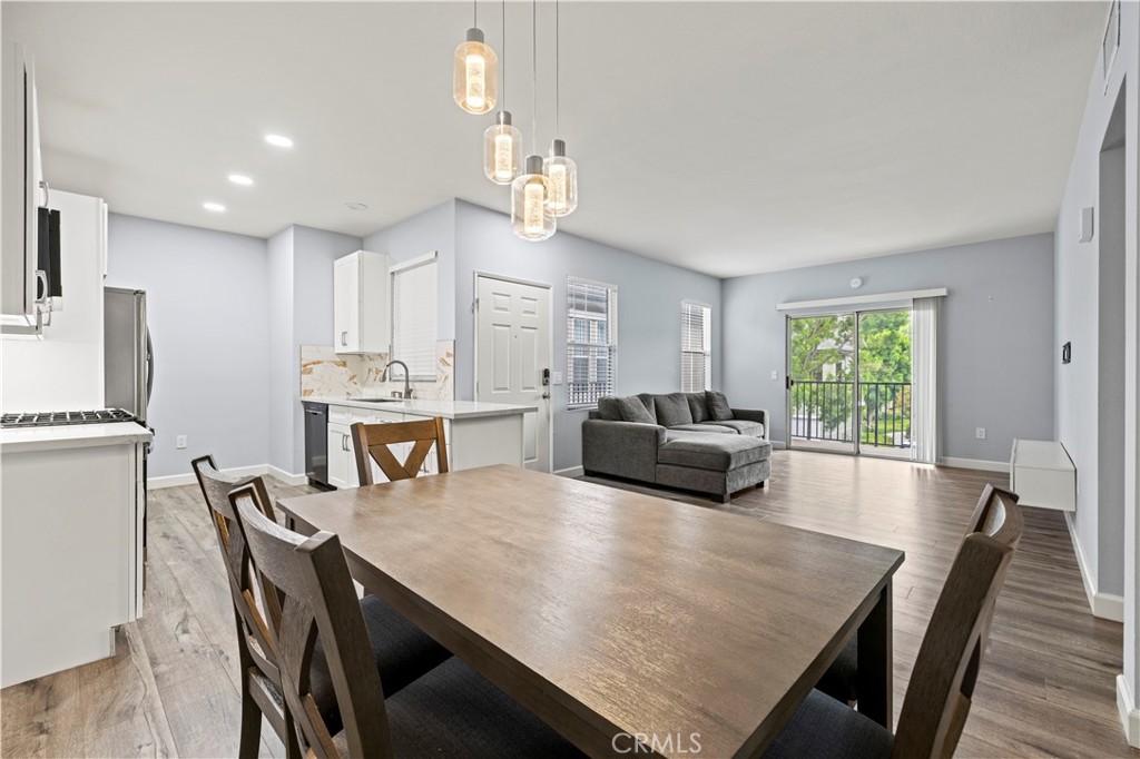 20000 Plum Canyon Road, Unit 1326 Saugus, CA 91350 - Photo 15 of 39 a view of a dining room with furniture window and wooden floor