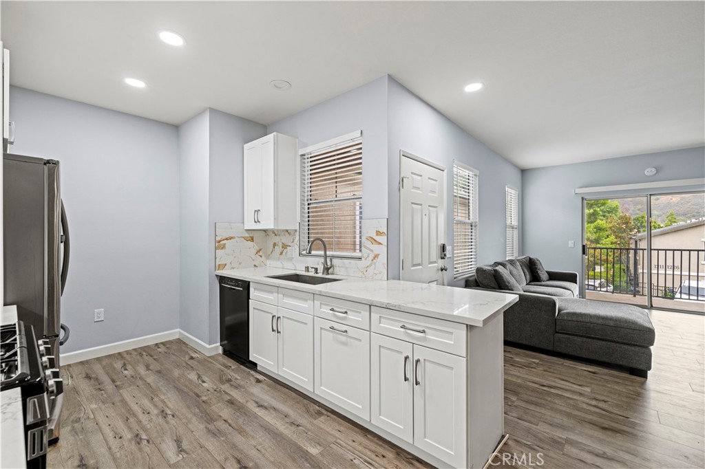 20000 Plum Canyon Road, Unit 1326 Saugus, CA 91350 - Photo 18 of 39 a large white kitchen with a window and refrigerator