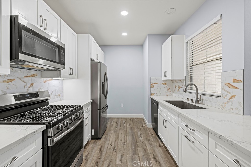 20000 Plum Canyon Road, Unit 1326 Saugus, CA 91350 - Photo 19 of 39 a kitchen with stainless steel appliances a sink stove and refrigerator