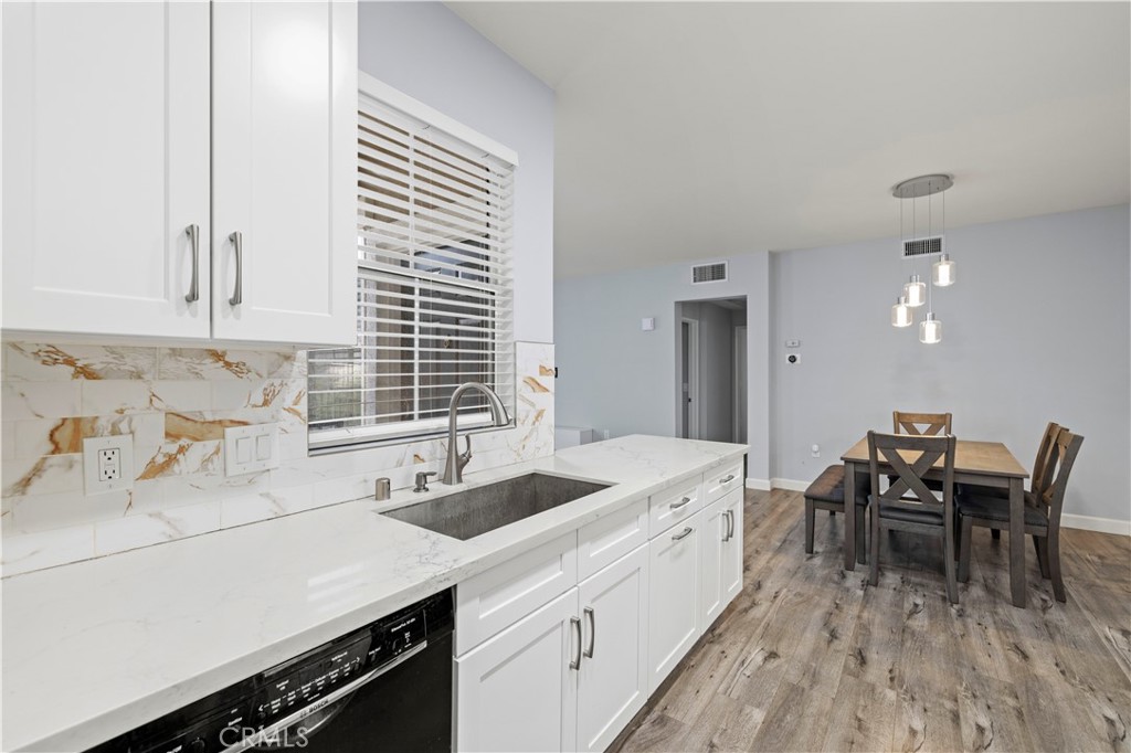 20000 Plum Canyon Road, Unit 1326 Saugus, CA 91350 - Photo 20 of 39 a kitchen with a sink cabinets and wooden floor