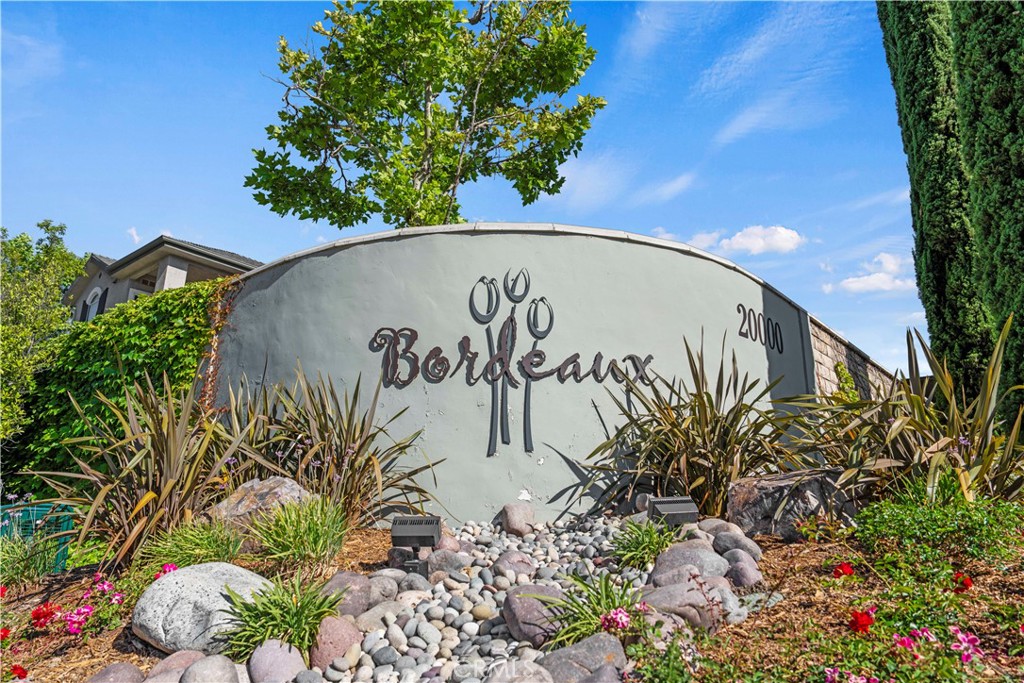 20000 Plum Canyon Road, Unit 1326 Saugus, CA 91350 - Photo 2 of 39 a street sign that is next to a blue wall