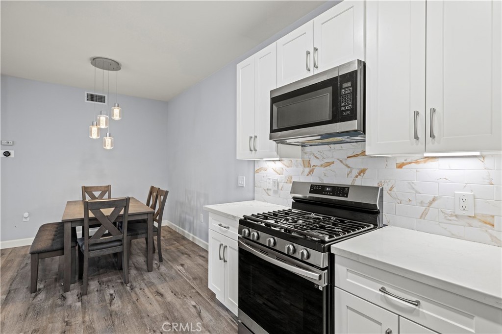 20000 Plum Canyon Road, Unit 1326 Saugus, CA 91350 - Photo 21 of 39 a kitchen with a stove and a microwave