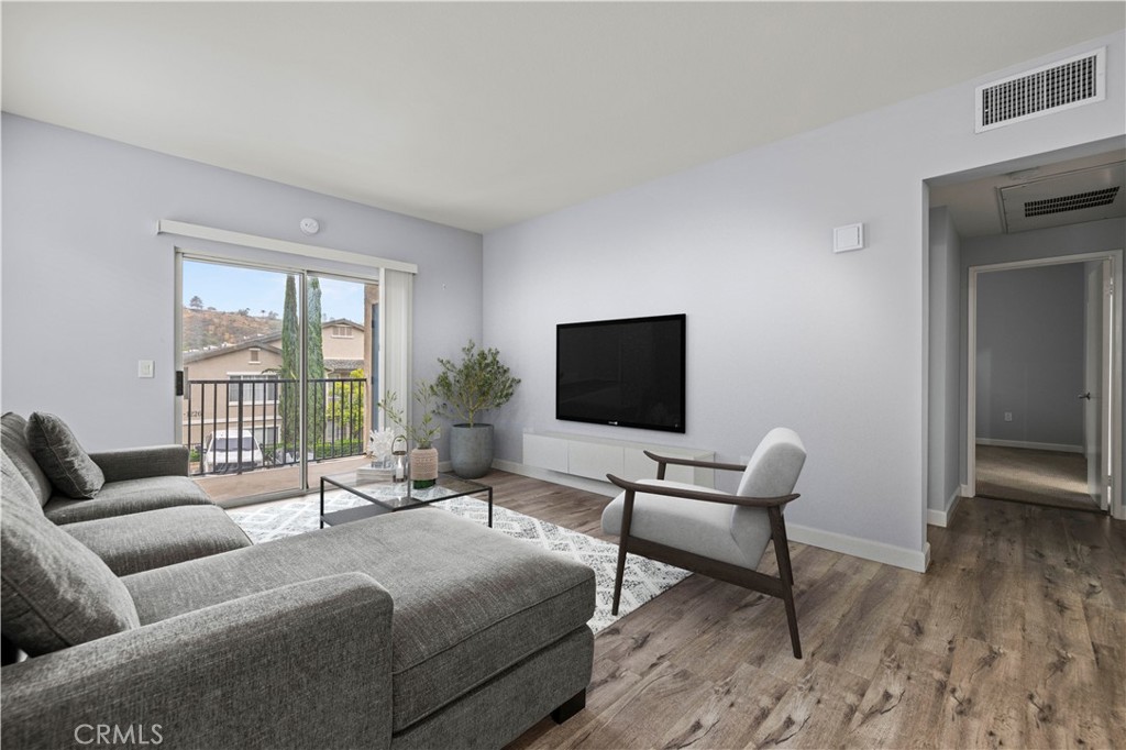 20000 Plum Canyon Road, Unit 1326 Saugus, CA 91350 - Photo 10 of 39 a living room with furniture and a flat screen tv