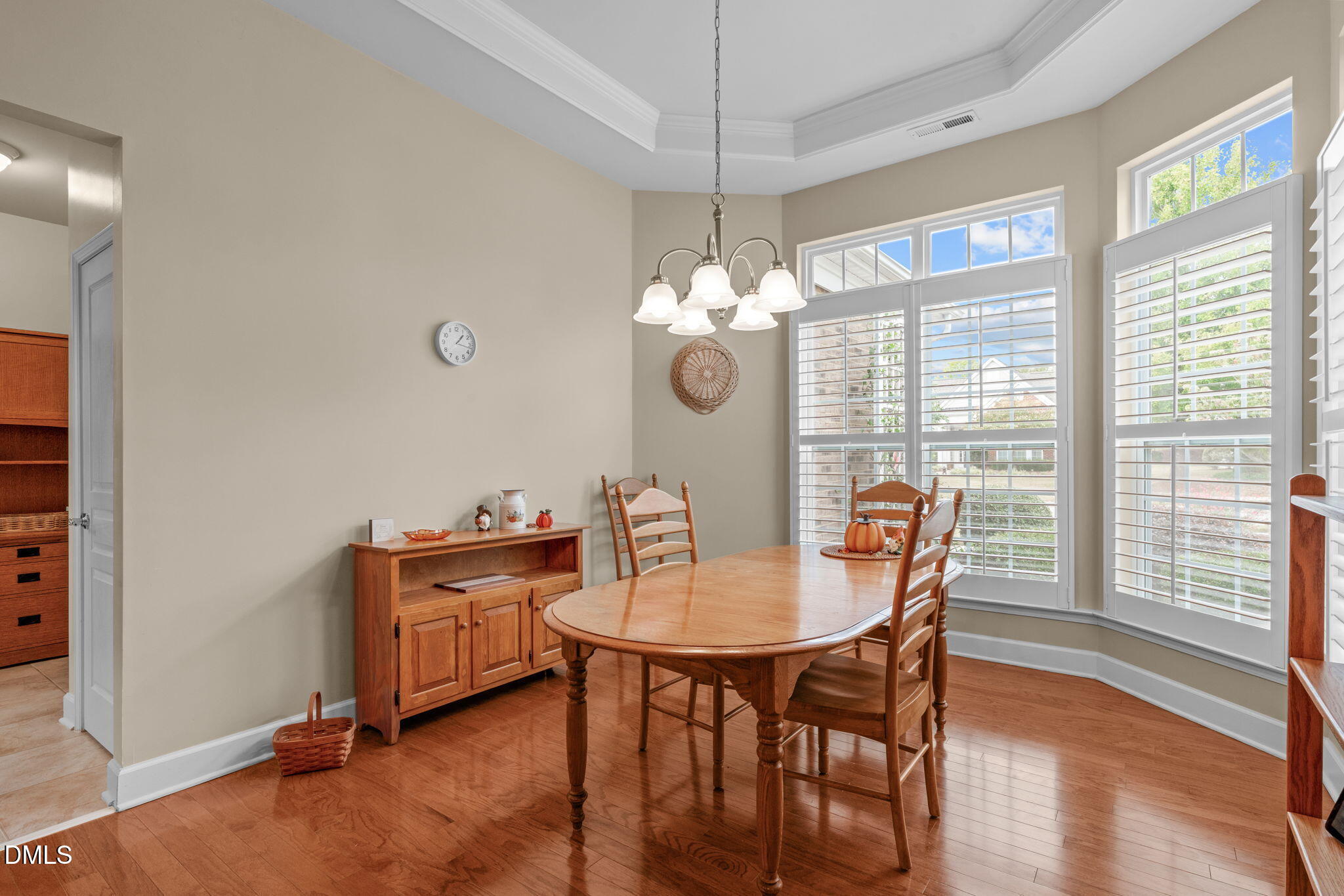 113 Beckingham Loop Cary, NC 27519 - Photo 26 of 57 a dining room with furniture a chandelier and wooden floor