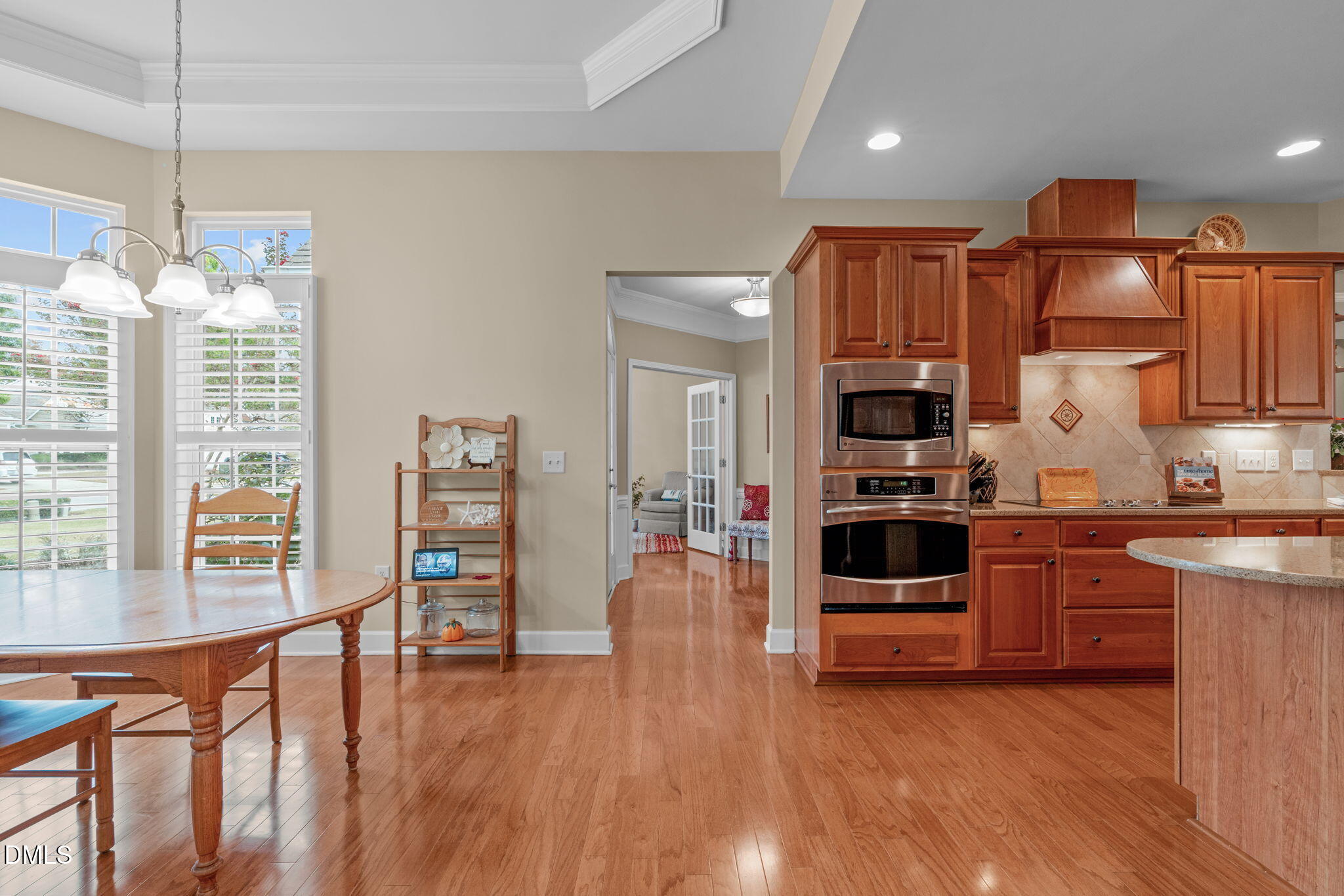 113 Beckingham Loop Cary, NC 27519 - Photo 28 of 57 a kitchen with stainless steel appliances granite countertop a refrigerator oven a stove and a wooden floors
