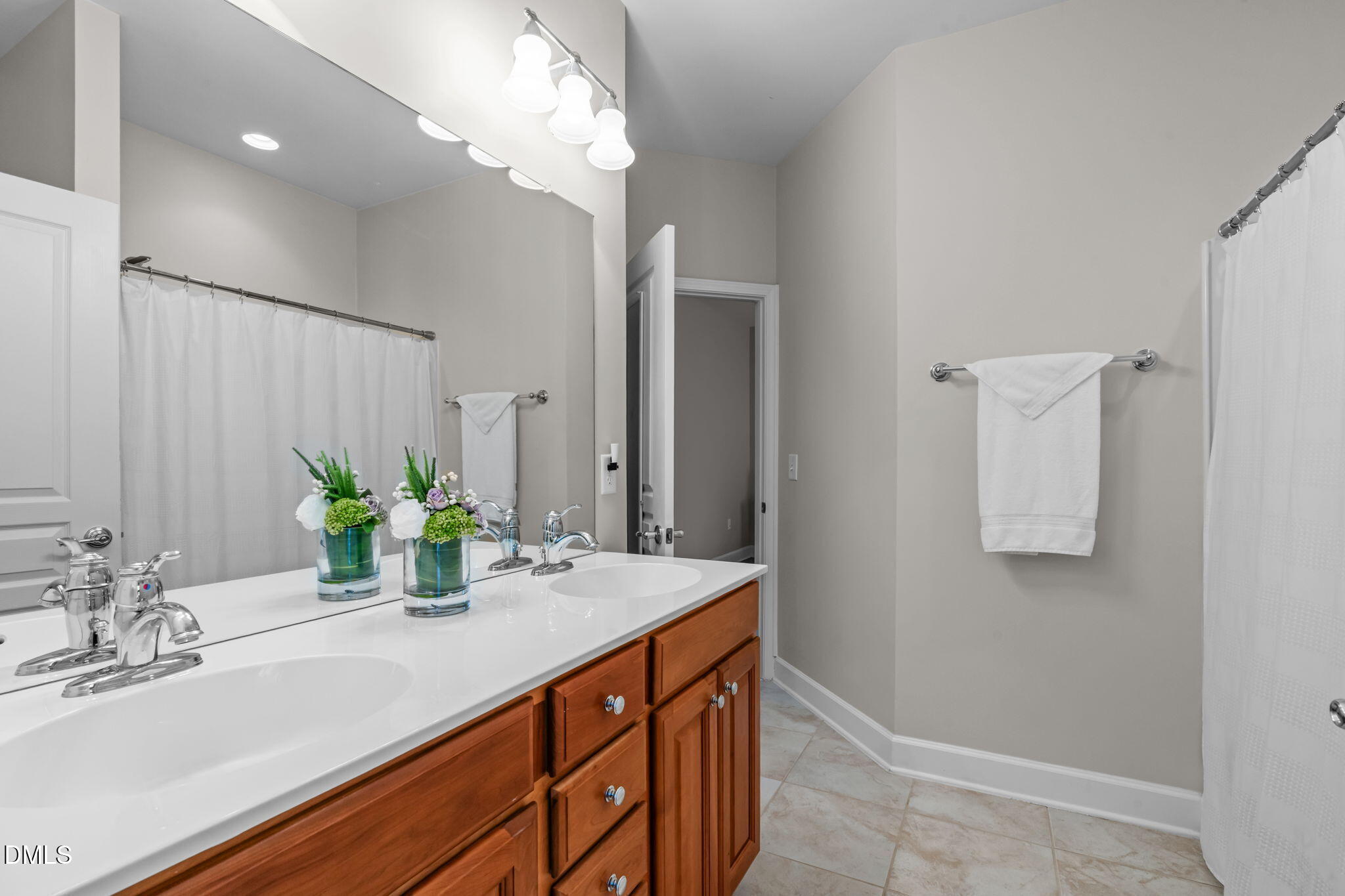 113 Beckingham Loop Cary, NC 27519 - Photo 40 of 57 a bathroom with a sink and a mirror