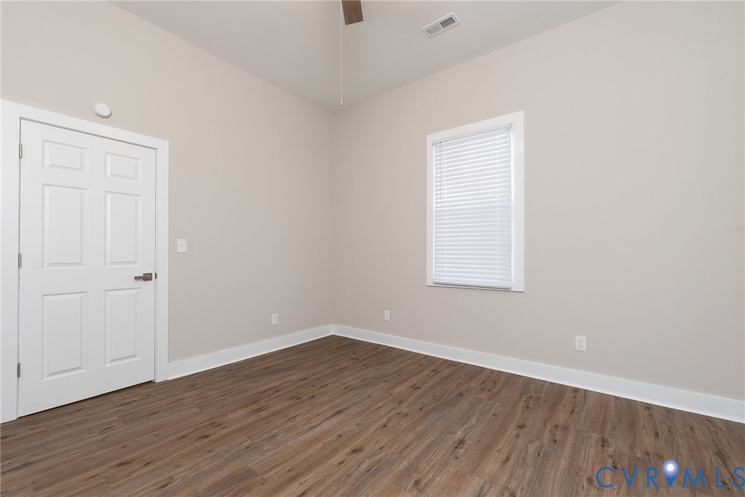 9800 Golf Course Drive Disputanta, VA 23842 - Photo 15 of 19 a view of a room with wooden floor and windows