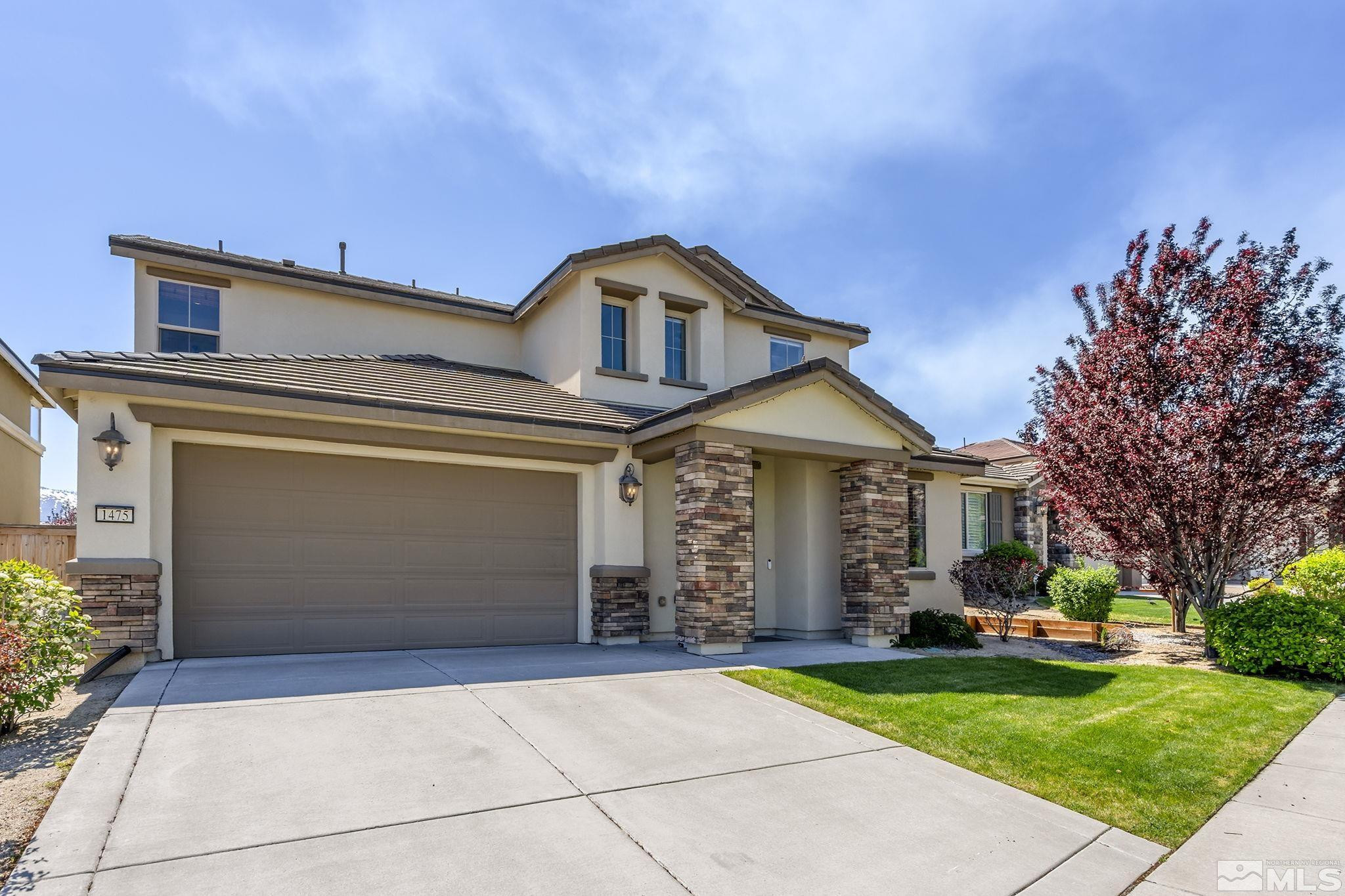 1475 Heavenly View Trail Reno, NV 89523 - Photo 1 of 33 a front view of a house with a yard and garage