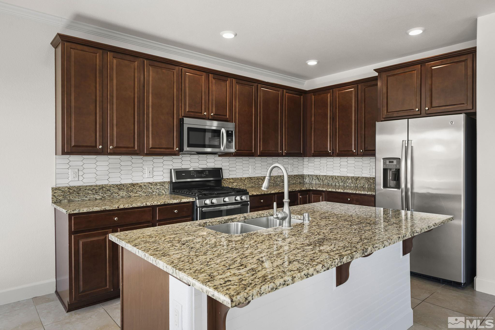 1475 Heavenly View Trail Reno, NV 89523 - Photo 8 of 33 a kitchen with kitchen island granite countertop a stove sink and refrigerator