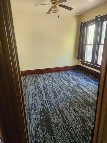 a view of a room with wooden floor and windows