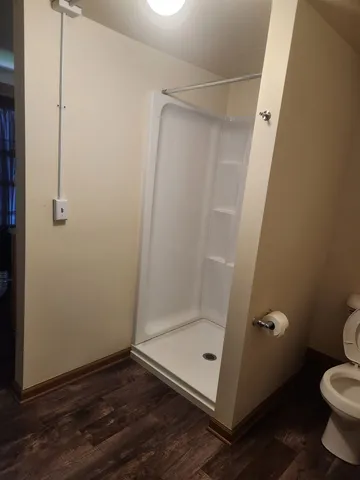 a bathroom with a glass shower door