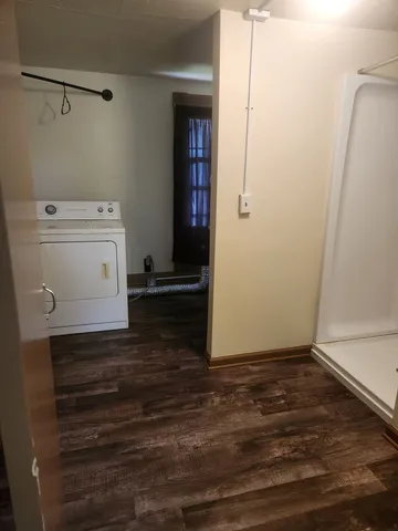 a utility room with cabinets washer and dryer