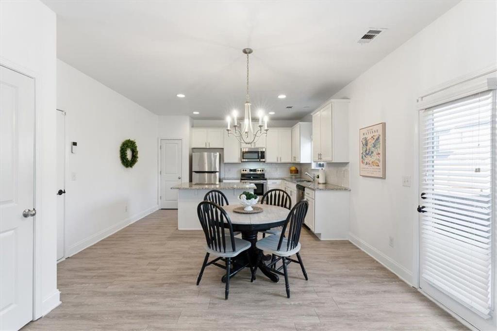 176 Village Way Southwest Calhoun, GA 30701 - Photo 15 of 53 a view of a dining room with furniture and a chandelier