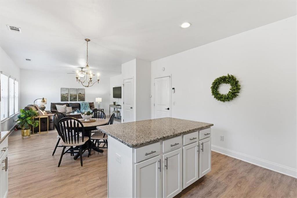 176 Village Way Southwest Calhoun, GA 30701 - Photo 19 of 53 a view of a dining room kitchen island with furniture and wooden floor