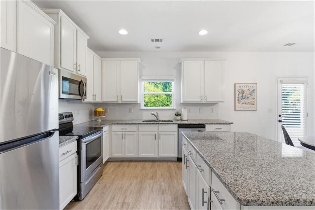 176 Village Way Southwest Calhoun, GA 30701 - Photo 20 of 53 a kitchen with granite countertop a sink stove and refrigerator