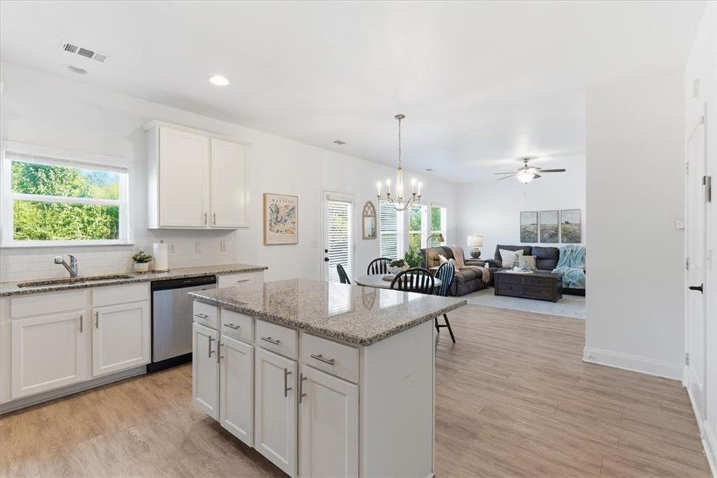 176 Village Way Southwest Calhoun, GA 30701 - Photo 21 of 53 a kitchen with center island white cabinets and stainless steel appliances