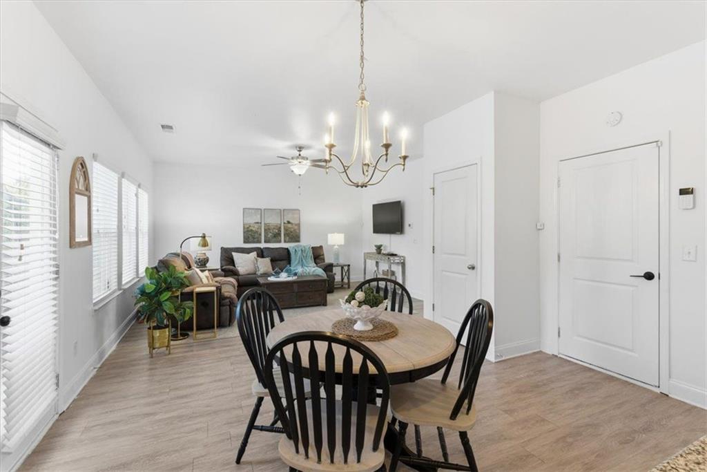 176 Village Way Southwest Calhoun, GA 30701 - Photo 22 of 53 a view of a dining room with furniture a chandelier and wooden floor
