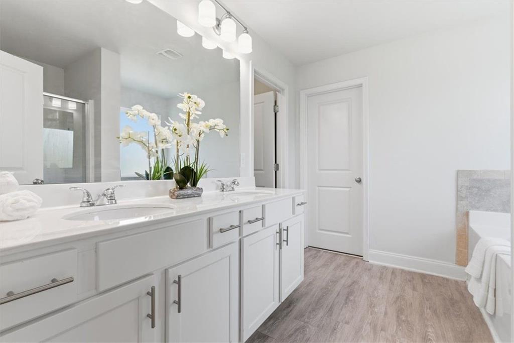 176 Village Way Southwest Calhoun, GA 30701 - Photo 27 of 53 a spacious bathroom with a granite countertop sink a mirror and a vanity