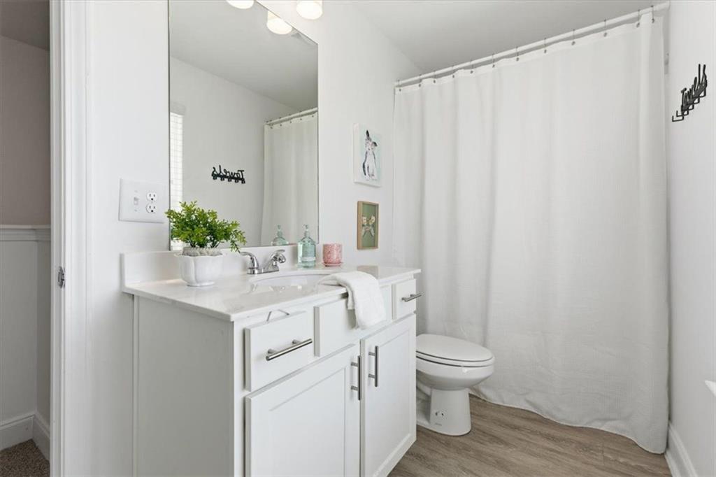 176 Village Way Southwest Calhoun, GA 30701 - Photo 33 of 53 a bathroom with a granite countertop sink a toilet and a mirror