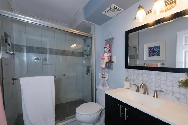 a bathroom with a sink toilet and shower