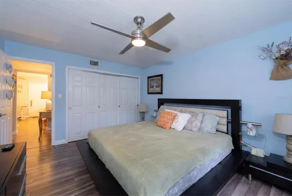 a bedroom with a large bed and a chandelier