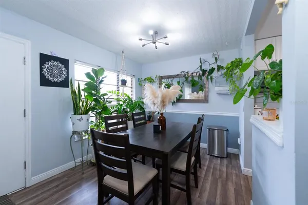 a view of a dining room with furniture and a potted plant