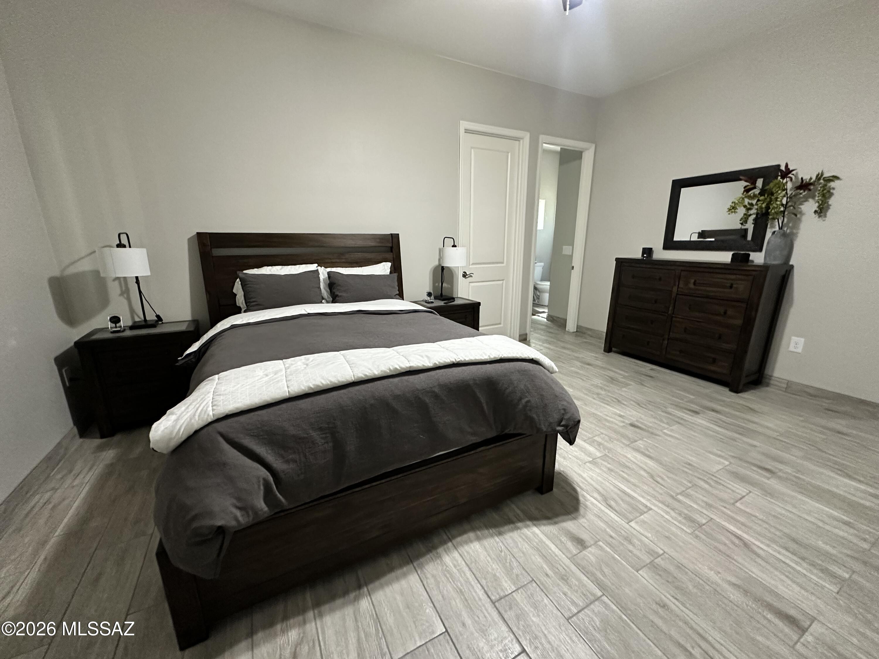 117 Ver Patria Rio Rico, AZ 85648 - Photo 15 of 28 a bedroom with a bed and wooden floor