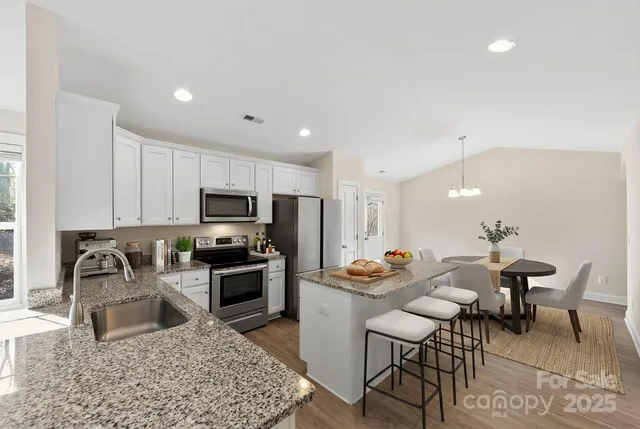 a view of a kitchen with a sink stainless steel appliances and cabinets