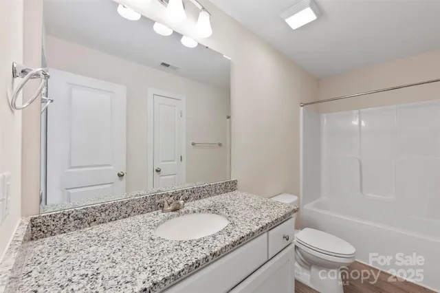 an empty room with a window and a ceiling fan