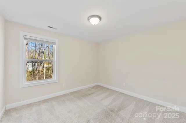 a view of a house with backyard and trees
