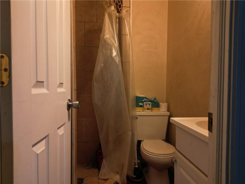 1119 Layton Road Butler, PA 16001 - Photo 16 of 25 a white toilet sitting next to a shower curtain