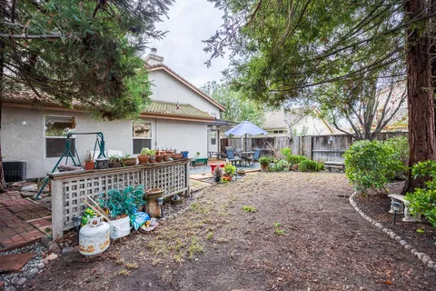 a view of a house with a patio and a yard