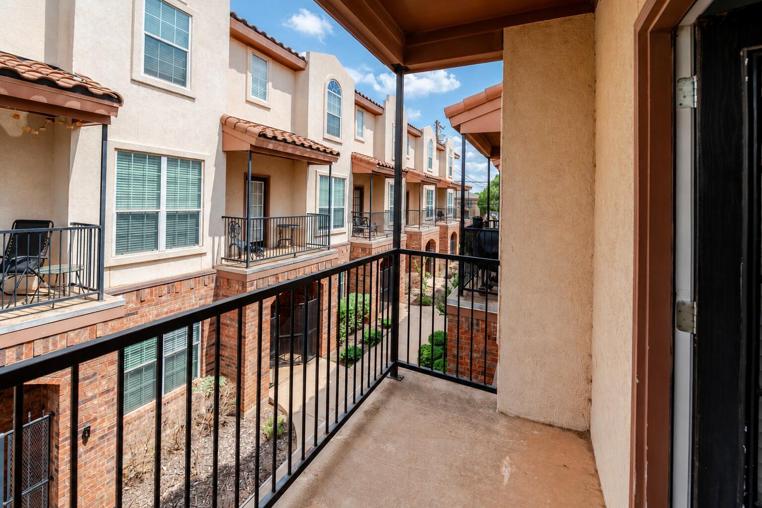 2111 Main Street, Unit 1 Lubbock, TX 79401 - Photo 32 of 36 a view of a brick house from a balcony