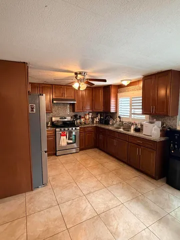 a large kitchen with cabinets and stainless steel appliances