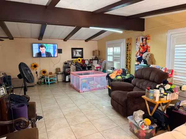 a living room with lots of furniture and a flat screen tv