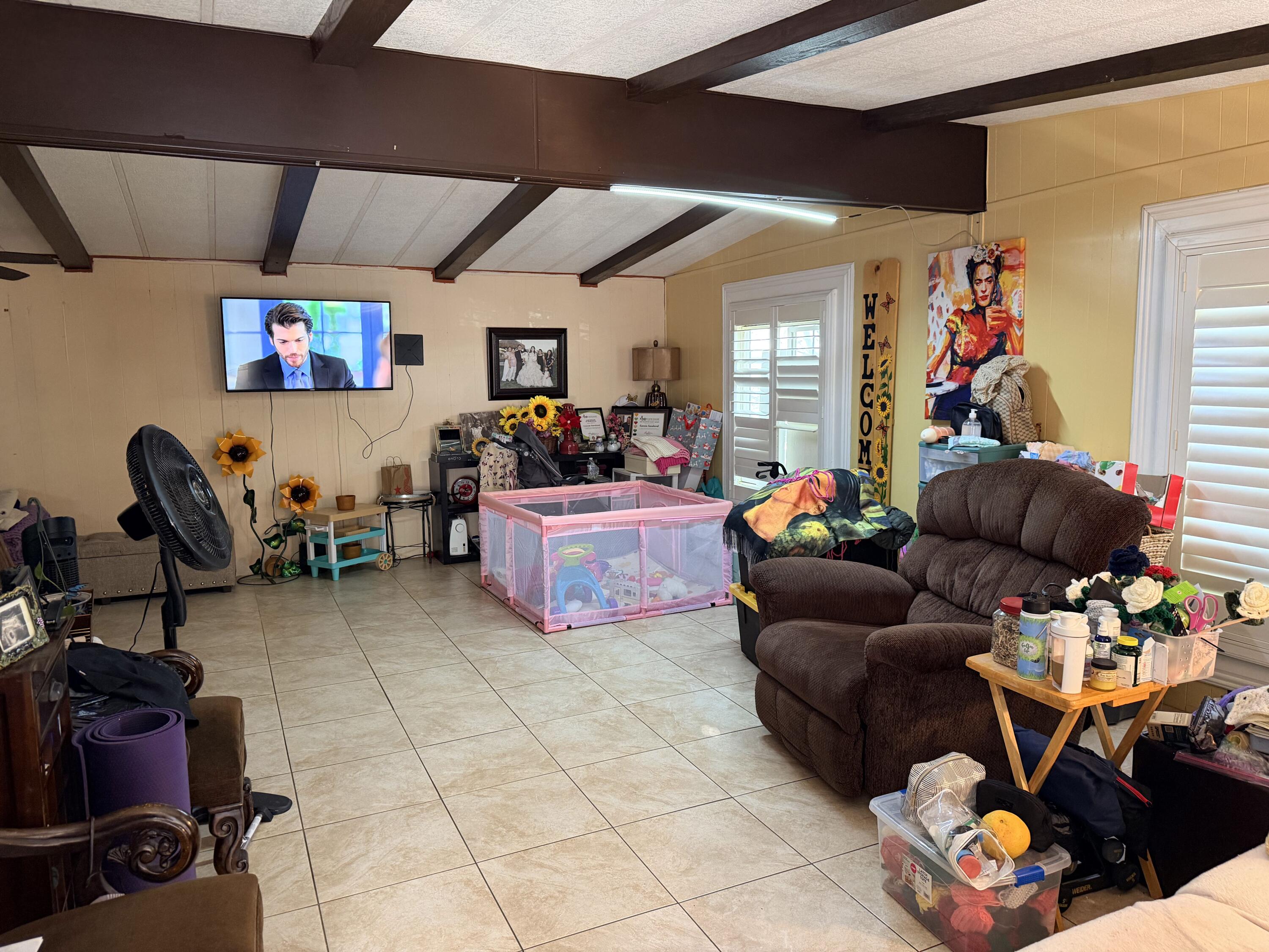 43532 Clinton Street, Unit 305 Indio, CA 92201 - Photo 3 of 3 a living room with lots of furniture and a flat screen tv