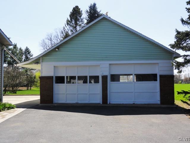 4541 Newburg Road Nazareth, PA 18064 - Photo 2 of 20 a front view of a house with a garden and trees
