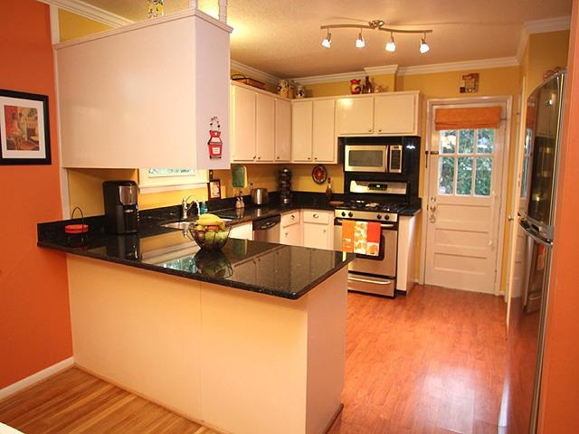 1120 Manchester Drive Raleigh, NC 27609 - Photo 5 of 13 Kitchen with updated Granite & SS Appliances. This overlooks Hearth Room for ease of entertaining. Kitchen