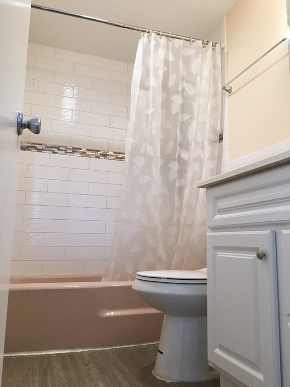388 Great Road, Unit B14 Acton, MA 01720 - Photo 12 of 14 a bathroom with a bathtub and a shower
