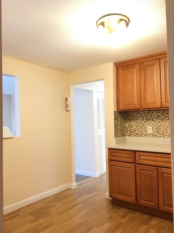 388 Great Road, Unit B14 Acton, MA 01720 - Photo 13 of 14 a view of room with wooden floor and cabinet