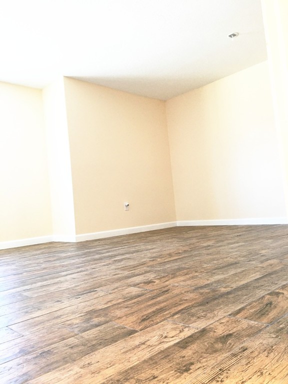 388 Great Road, Unit B14 Acton, MA 01720 - Photo 7 of 14 a view of a room with wooden floor