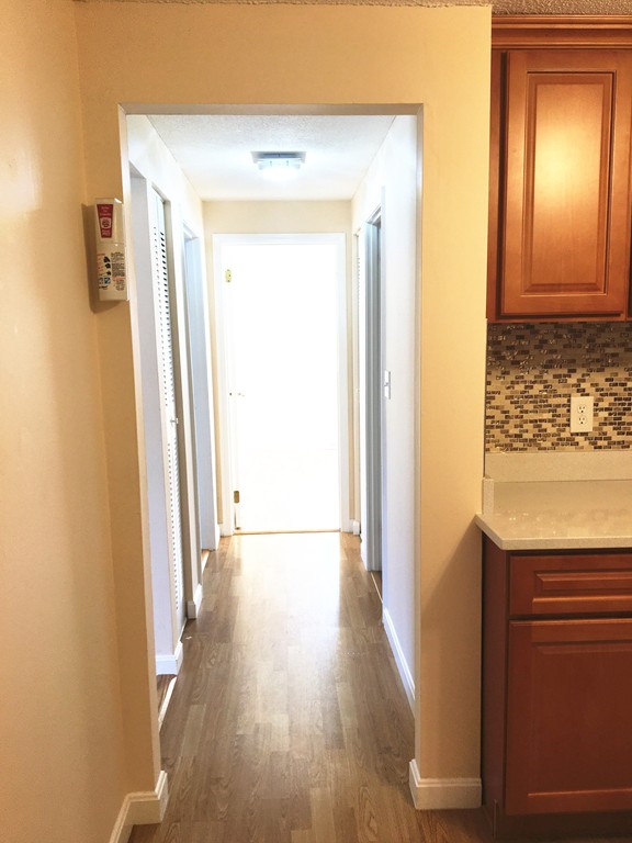 388 Great Road, Unit B14 Acton, MA 01720 - Photo 9 of 14 a view of a hallway with wooden floor
